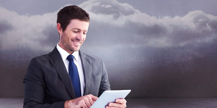 Businessman using his tablet pc  against clouds in a room