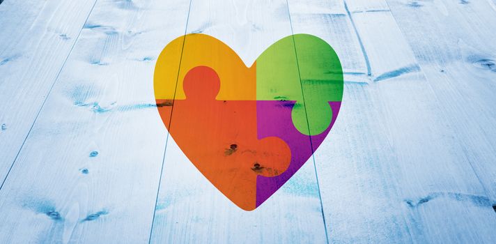 Autism awareness heart against bleached wooden planks background
