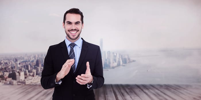 Happy businessman standing and applauding against city scene in a room