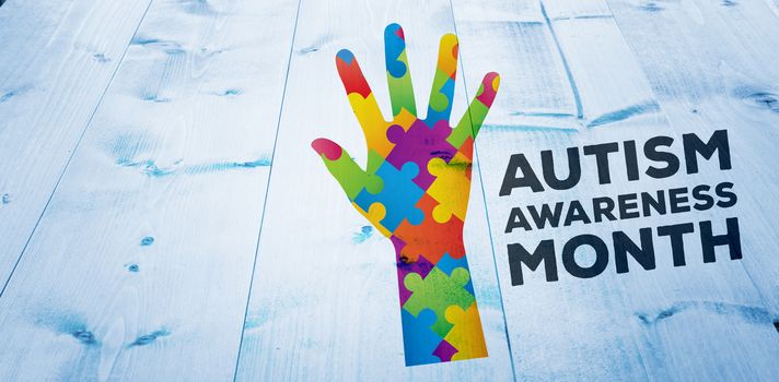 Autism awareness month against bleached wooden planks background