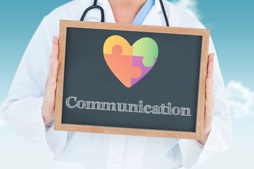 The word communication and doctor showing chalkboard against blue sky