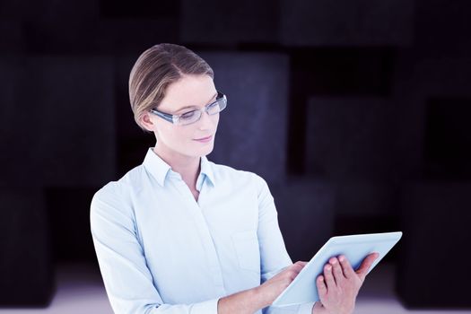 Businesswoman using tablet pc  against abstract black room
