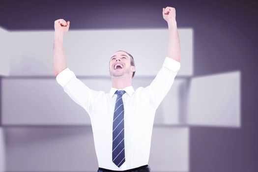 Handsome businessman cheering with arms up against abstract room