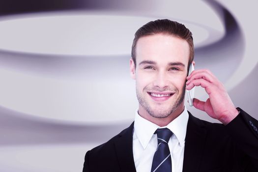 Portrait of a happy businessman phoning against white abstract room