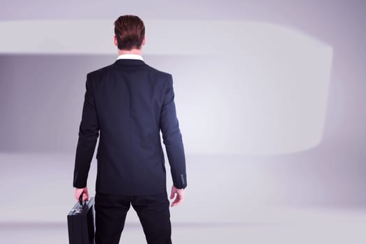 Rear view businessman standing with his briefcase against white abstract room