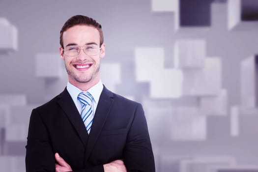 Smiling businessman in suit with arms crossed against abstract white room