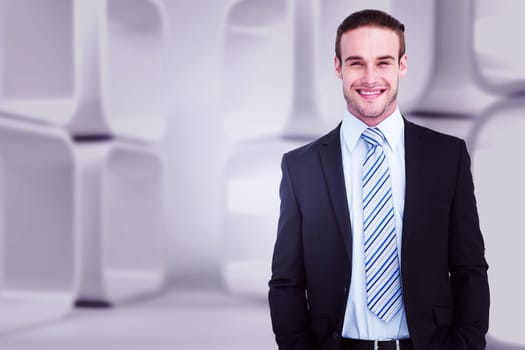 Smiling elegant businessman with hands in pockets against white abstract room