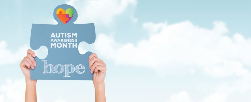 Hands showing jigsaw puzzle against blue sky