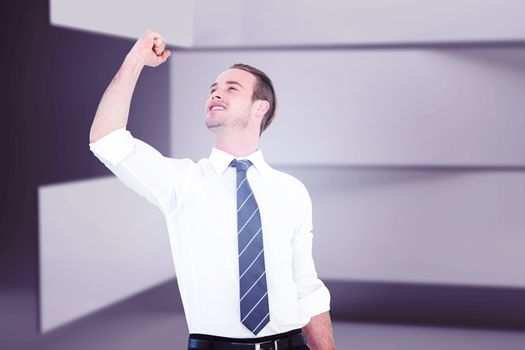 Businessman cheering with clenched fist against abstract room
