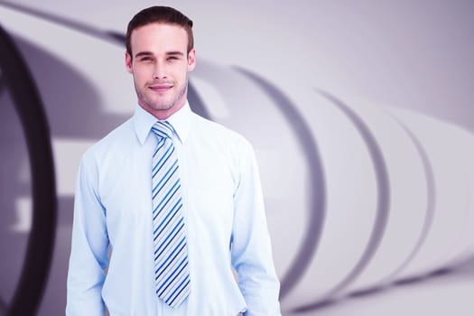 Cheerful businessman posing with hands in pockets against white abstract room