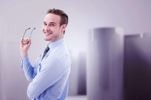 Businessman smiling against abstract white room