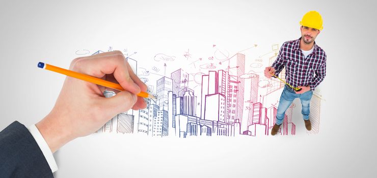 Hand writing with a pencil against large city buildings together