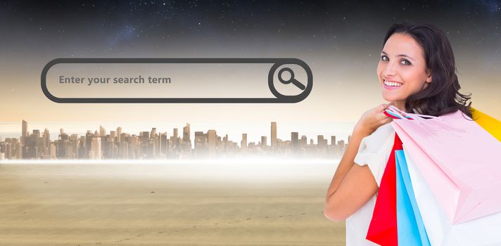 Pretty brunette with shopping bags against city on the horizon