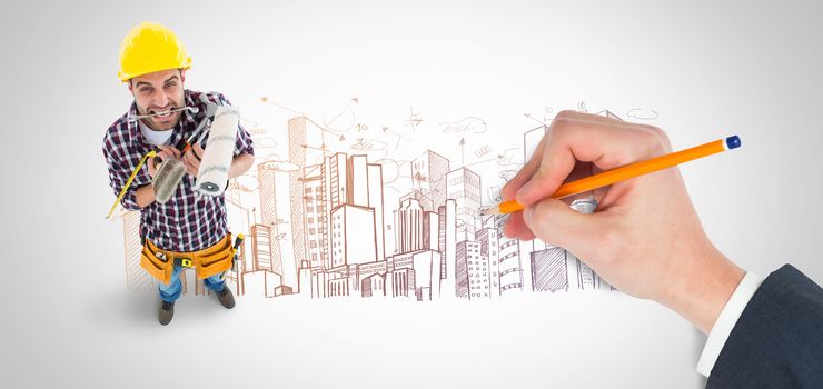 Hand writing with a pencil against large city buildings together