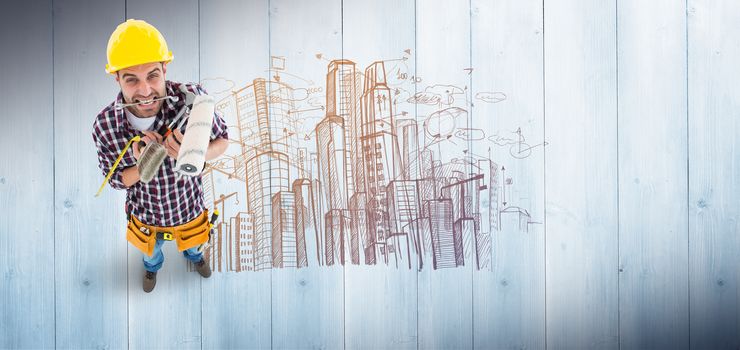 Frustrated handyman holding various tools against pale grey wooden planks