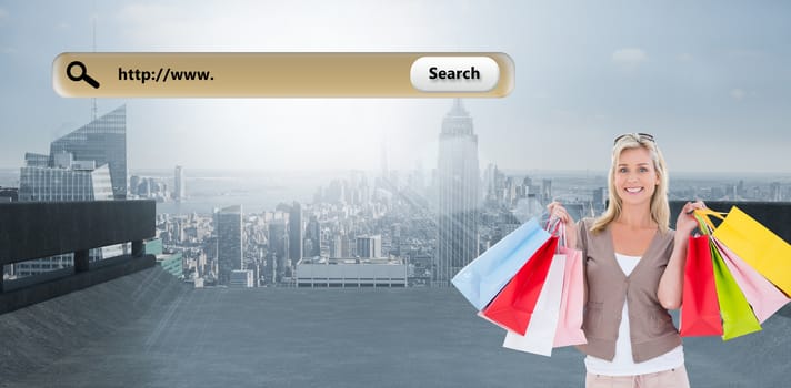 Happy blonde holding shopping bags against large city on the horizon