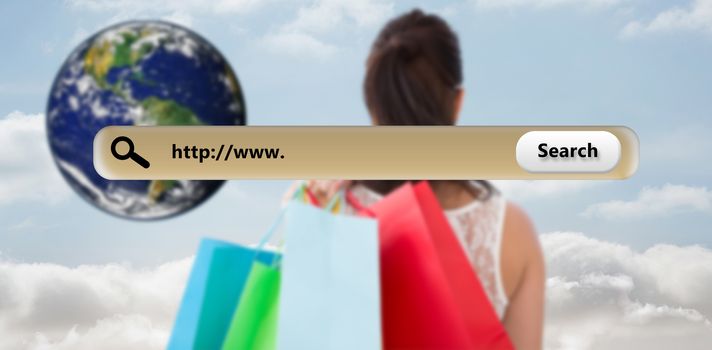 Rear view of brunette holding shopping bags against cloudy sky