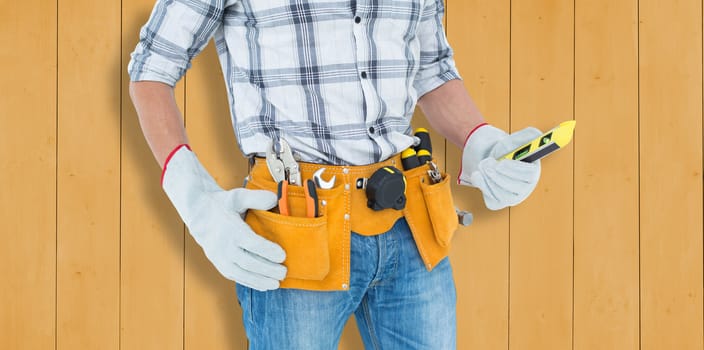 Technician holding spirit level over white background against wooden planks