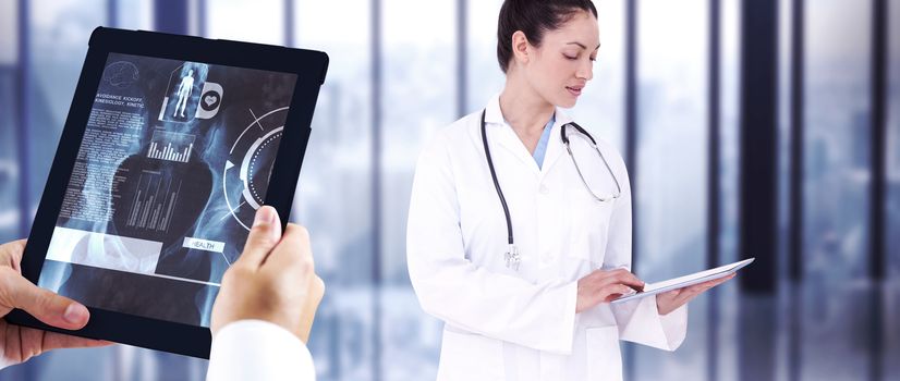 Man using tablet pc against room with large window looking on city