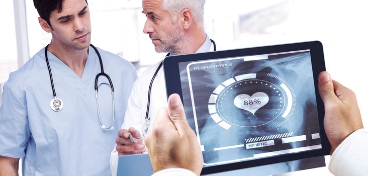 Man using tablet pc against doctors talking about a file