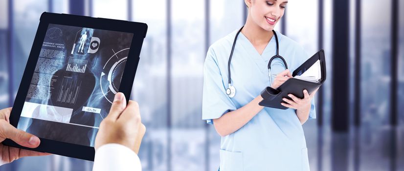 Man using tablet pc against room with large window looking on city