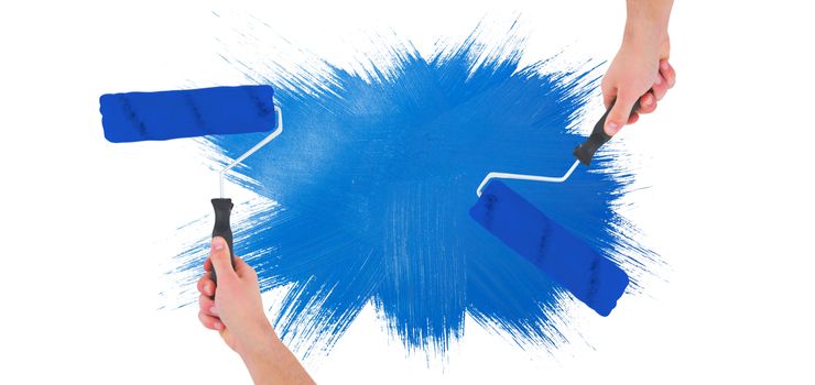 Handyman holding paint roller  against blue paint