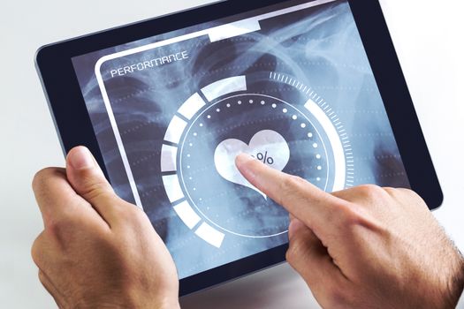 Man using tablet pc against medical interface on xray