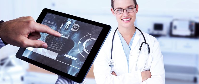 Man using tablet pc  against empty bed in the hospital room