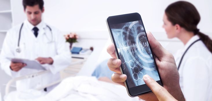 hand holding smartphone against medical interface on xray