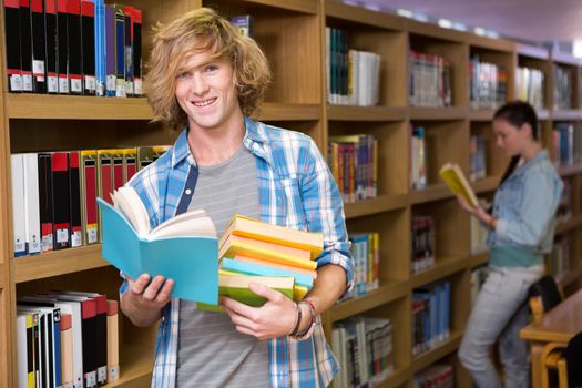 Student smiling at camera in library at the university