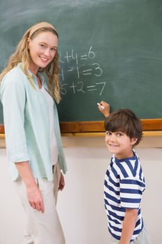Teacher explaining mathematics to a pupil at elementary school 
