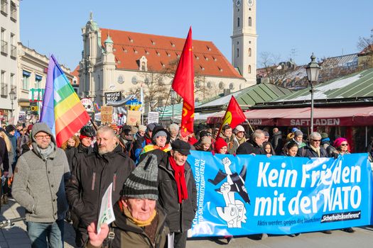 Munich, Germany - February 7, 2015: Peaceful anti-NATO social protest march against the aggressive policy USA in Europe and presence army North Atlantic Alliance military forces.