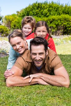 Happy family smiling at camera in the countryside