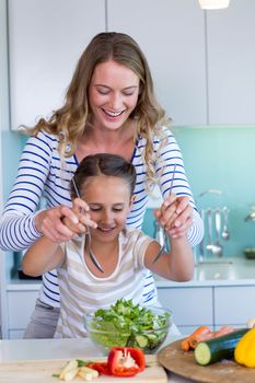 Happy family preparing lunch together at home in the kitchen