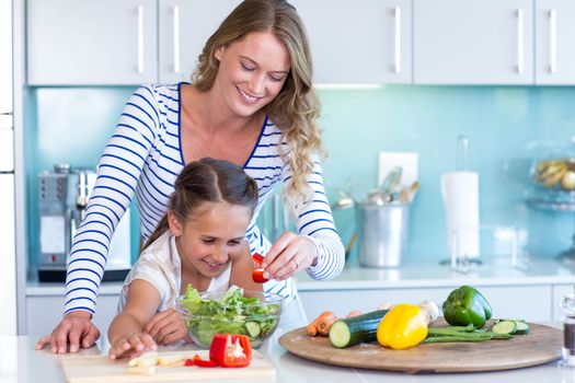 Happy family preparing lunch together at home in the kitchen