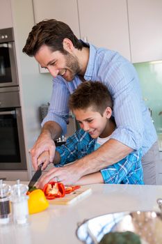 Happy family preparing vegetables together at home in the kitchen