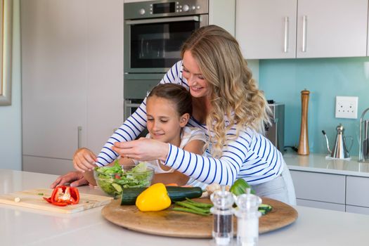 Happy family preparing lunch together at home in the kitchen