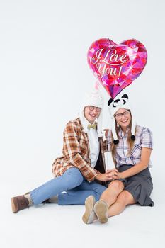 Geeky hipster in love couple looking at camera on white background 