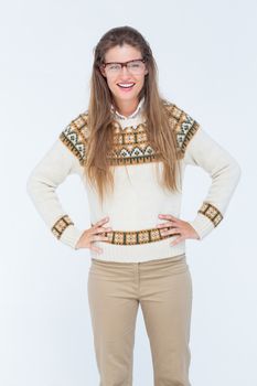 Happy geeky hipster smiling at camera on white background