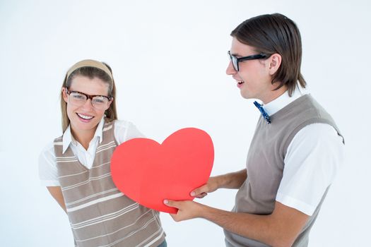 Geeky hipster offering red heart to his girlfriend on white background 