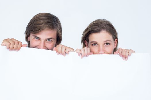 Hipster couple holding poster on white background