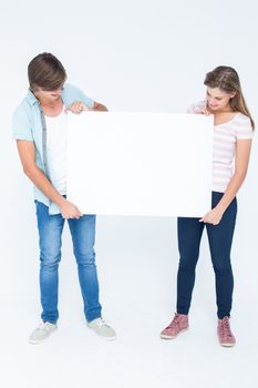 Hipster couple holding poster on white background