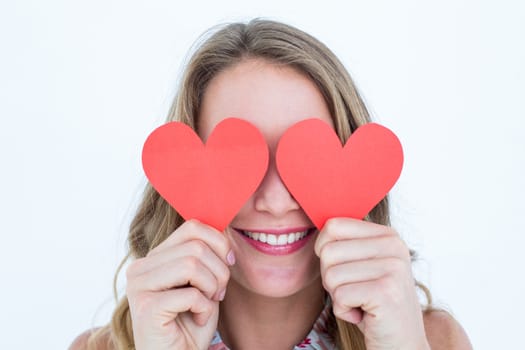 Woman holding heart cards on white background 