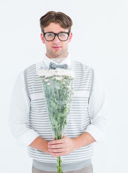 Geeky hipster offering bunch of flowers on white background