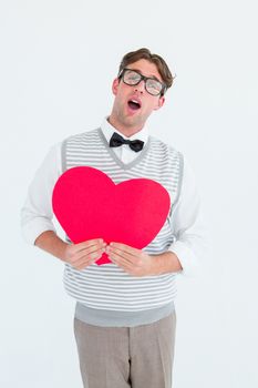 Geeky hipster holding heart card on white background