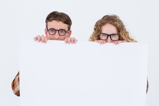 Geeky hipster couple holding poster on white background