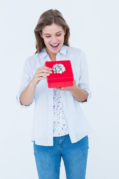 Happy woman opening a present on white background
