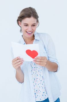Smiling woman reading love letter on white background
