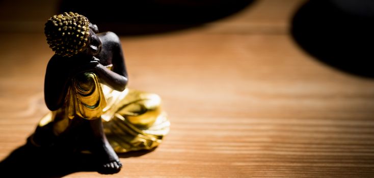 Wooden buddha statue on table shot in studio