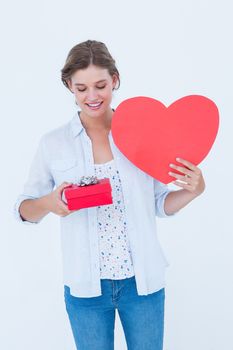 Woman holding a present and heart card on white background